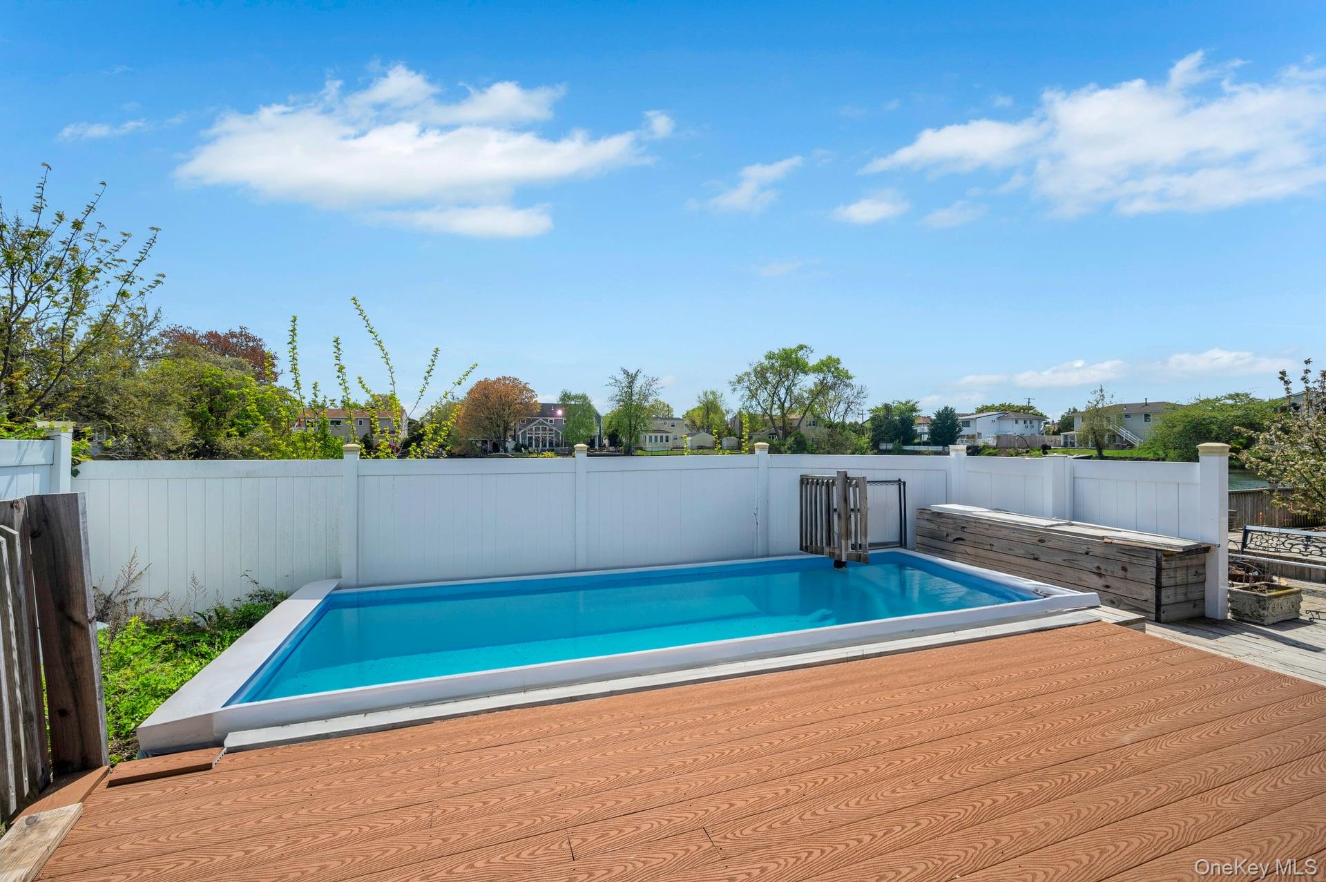 24 Raynor Street West Babylon, NY 11704 - Photo 40 of 45 View of swimming pool with a fenced backyard and a wooden deck