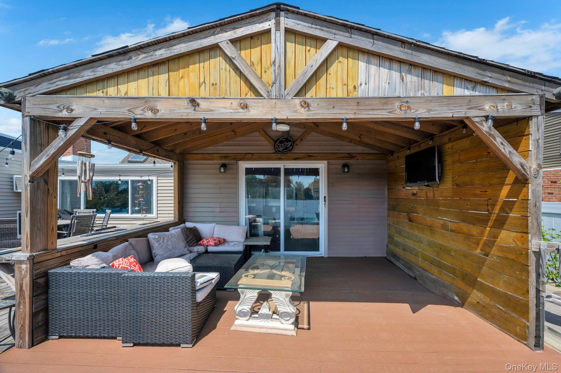 24 Raynor Street West Babylon, NY 11704 - Photo 41 of 45 Wooden terrace with an outdoor hangout area