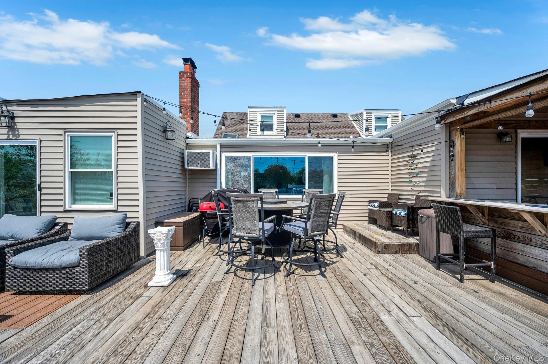 24 Raynor Street West Babylon, NY 11704 - Photo 42 of 45 Deck with outdoor dining space