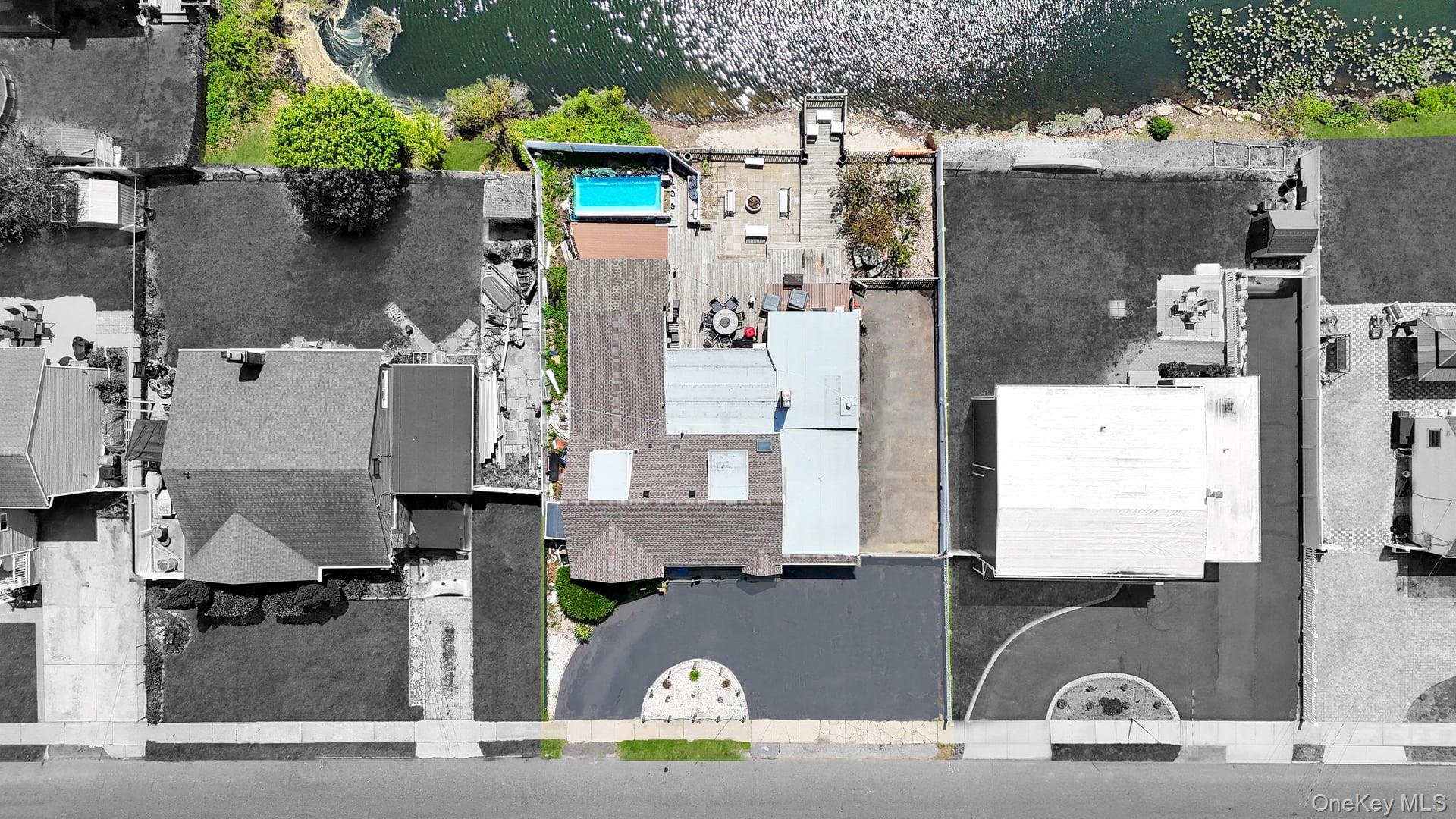 24 Raynor Street West Babylon, NY 11704 - Photo 7 of 45 Aerial view of residential area featuring a pool area and a large body of water