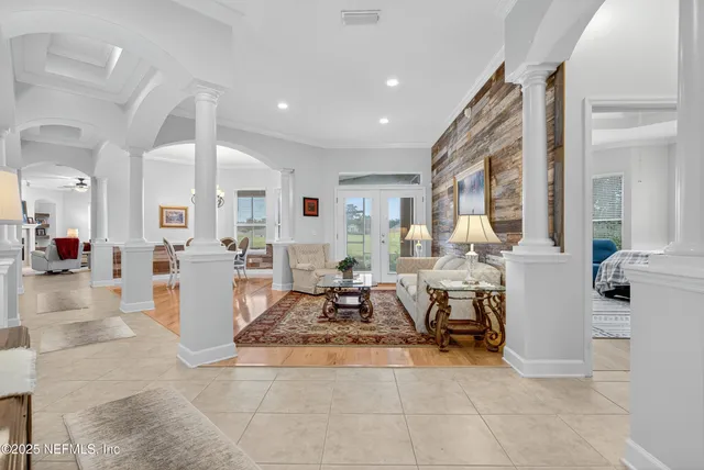 a living room with furniture a large window and dining table