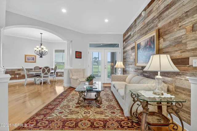 a living room with furniture and a chandelier