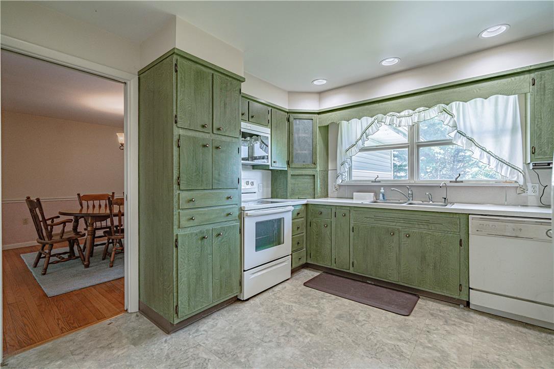 4815 Mill Road Schnecksville, PA 18078 - Photo 17 of 48 Green cabinetry and abundant natural light define this welcoming kitchen space.