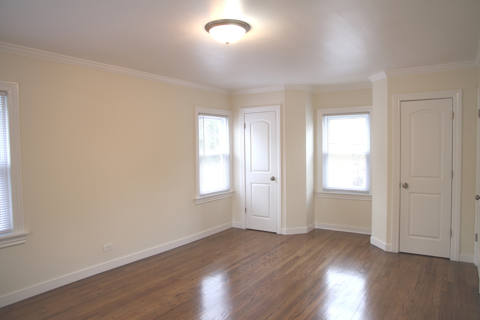 10132 South Green Street Chicago, IL 60643 - Photo 20 of 26 an empty room with wooden floor and windows