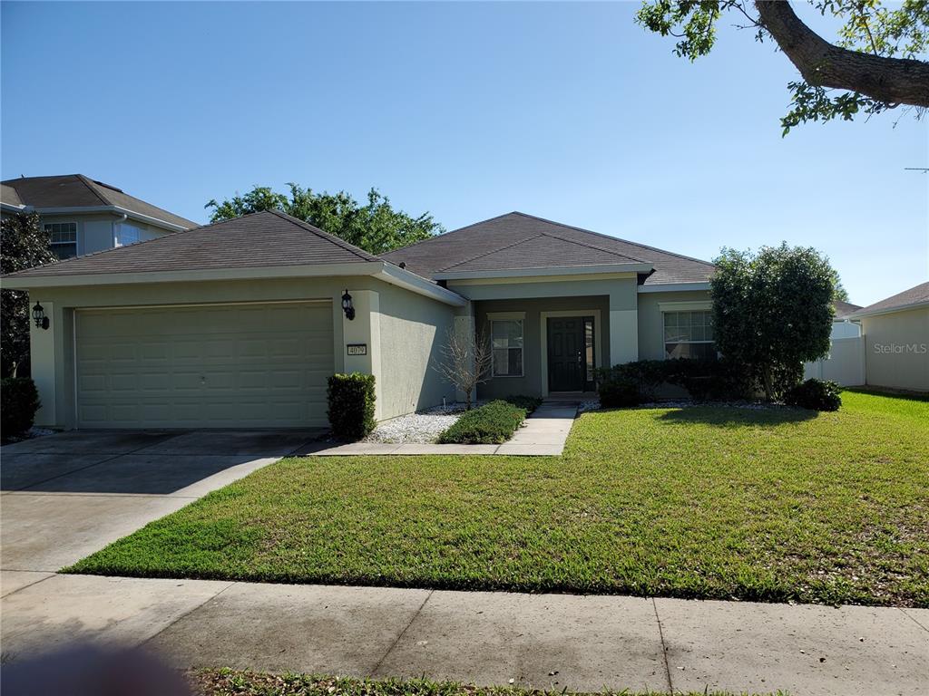 a front view of a house with a yard and garage