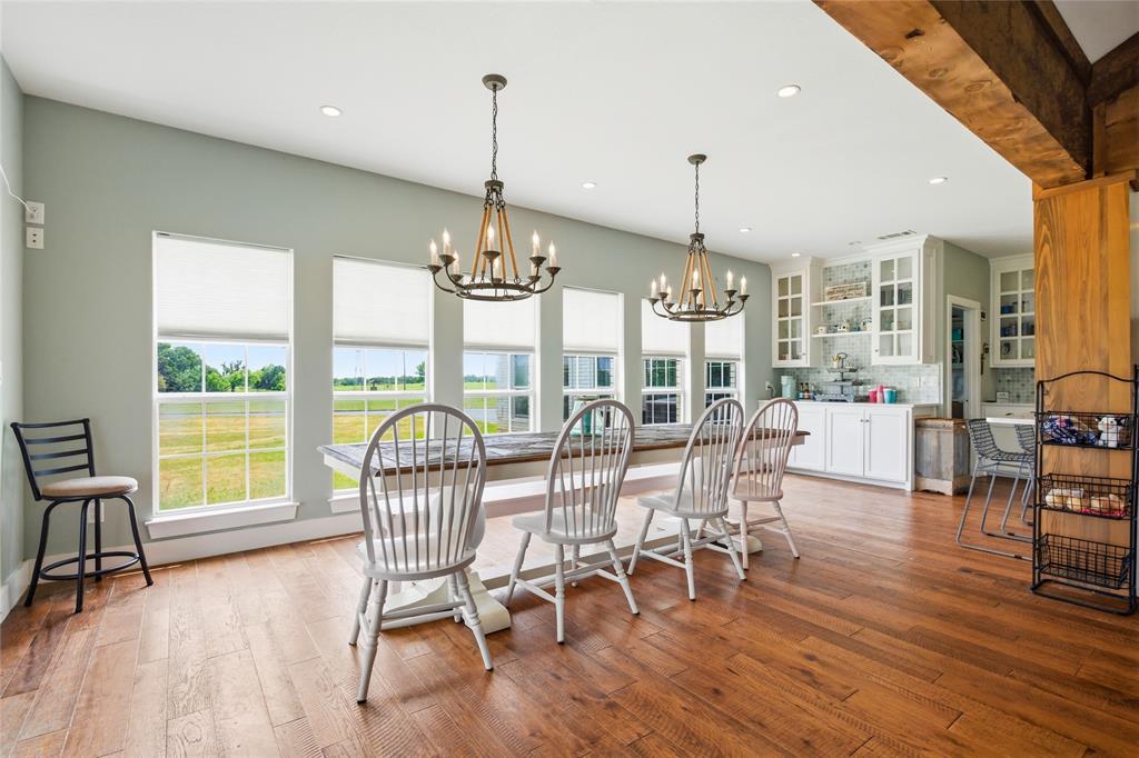 1073 Gordonville Road Gordonville, TX 76245 - Photo 16 of 38 Moving to the right side of the home, a large dining area with landscape views provides for ample room to dine, visit, and enjoy each other's company. A coffee bar within the custom built kitchen cabinet also highlights this area.