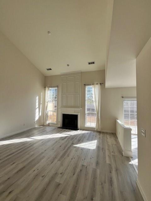 915 Wendlebury Court Alpharetta, GA 30004 - Photo 4 of 27 a view of empty room with wooden floor and fireplace