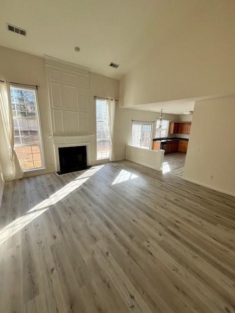 915 Wendlebury Court Alpharetta, GA 30004 - Photo 7 of 27 a view of empty room with wooden floor and fireplace