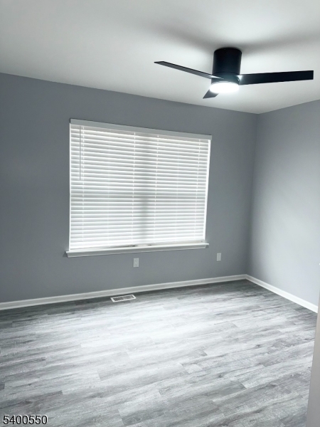 68 Marrow Street Newark, NJ 07103 - Photo 13 of 17 an empty room with wooden floor and windows