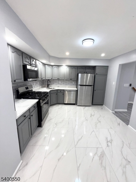 68 Marrow Street Newark, NJ 07103 - Photo 2 of 17 a kitchen with stainless steel appliances granite countertop a sink stove and refrigerator