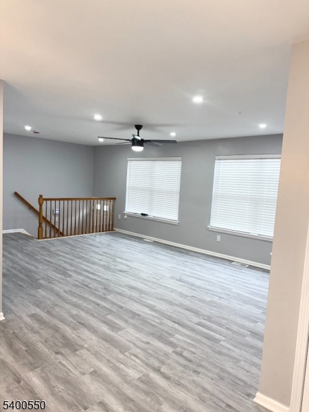 68 Marrow Street Newark, NJ 07103 - Photo 5 of 17 an empty room with wooden floor and windows