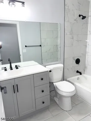 a bathroom with a double vanity sink toilet and shower