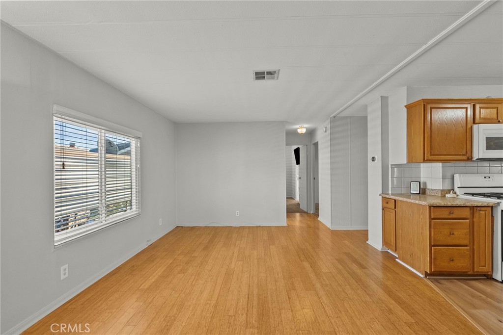 6480 Katherine, Unit 75 Simi Valley, CA 93063 - Photo 16 of 30 a view of a kitchen with wooden floor and a sink