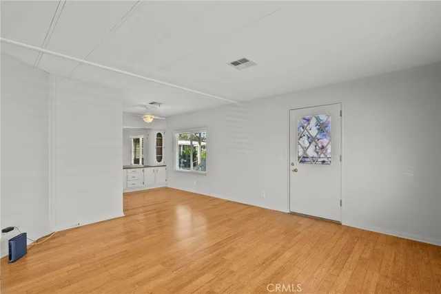 a view of empty room with wooden floor