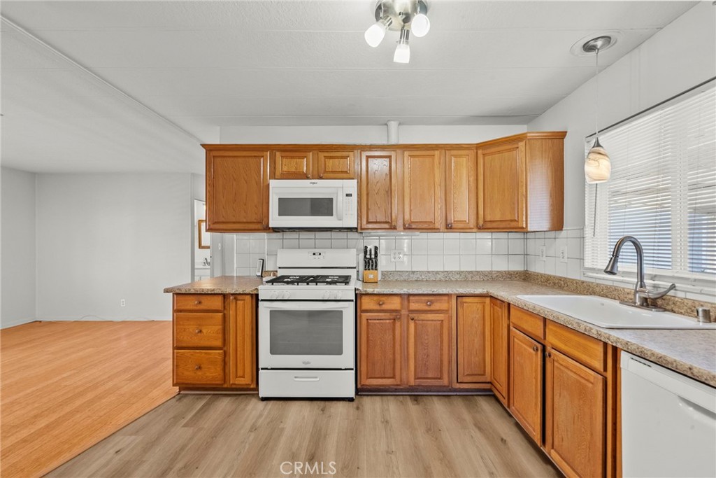6480 Katherine, Unit 75 Simi Valley, CA 93063 - Photo 22 of 30 a kitchen with stainless steel appliances granite countertop a sink cabinets and wooden floor