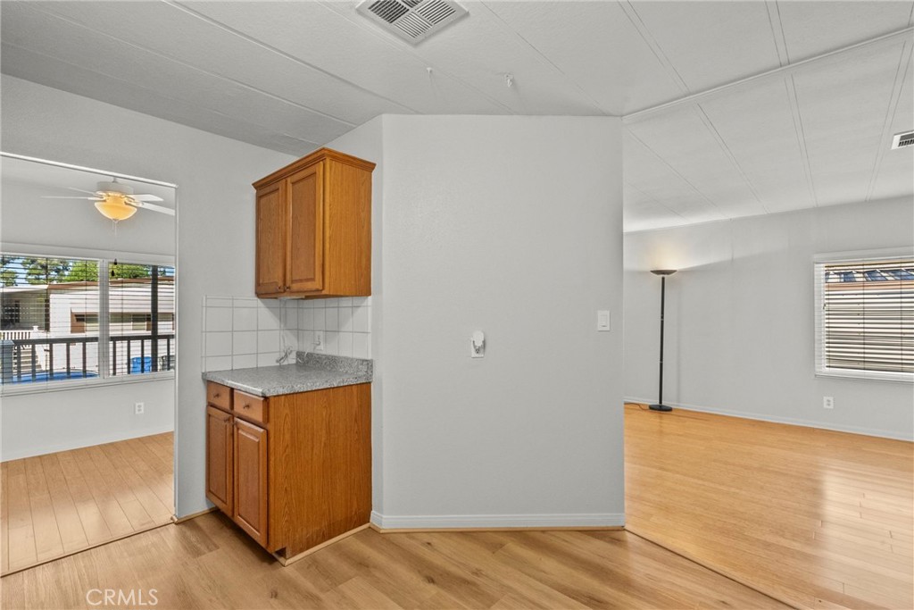 6480 Katherine, Unit 75 Simi Valley, CA 93063 - Photo 23 of 30 a view of a room with wooden floor and cabinet