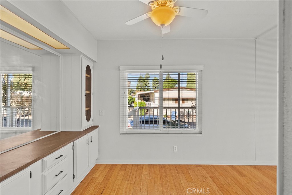 6480 Katherine, Unit 75 Simi Valley, CA 93063 - Photo 24 of 30 a view of an empty room with wooden floor and a window