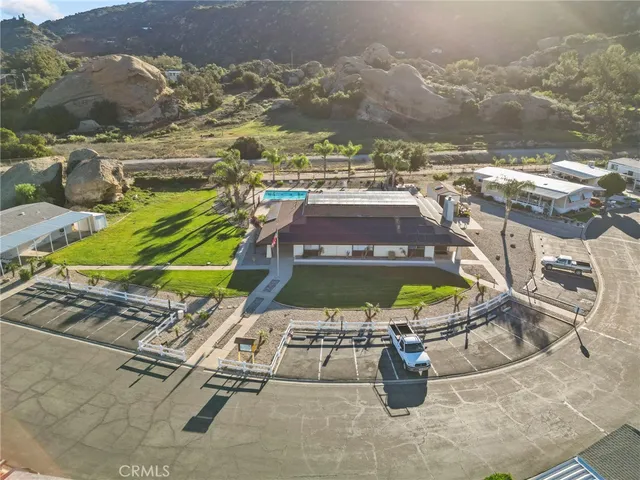 an aerial view of a tennis ground with large trees
