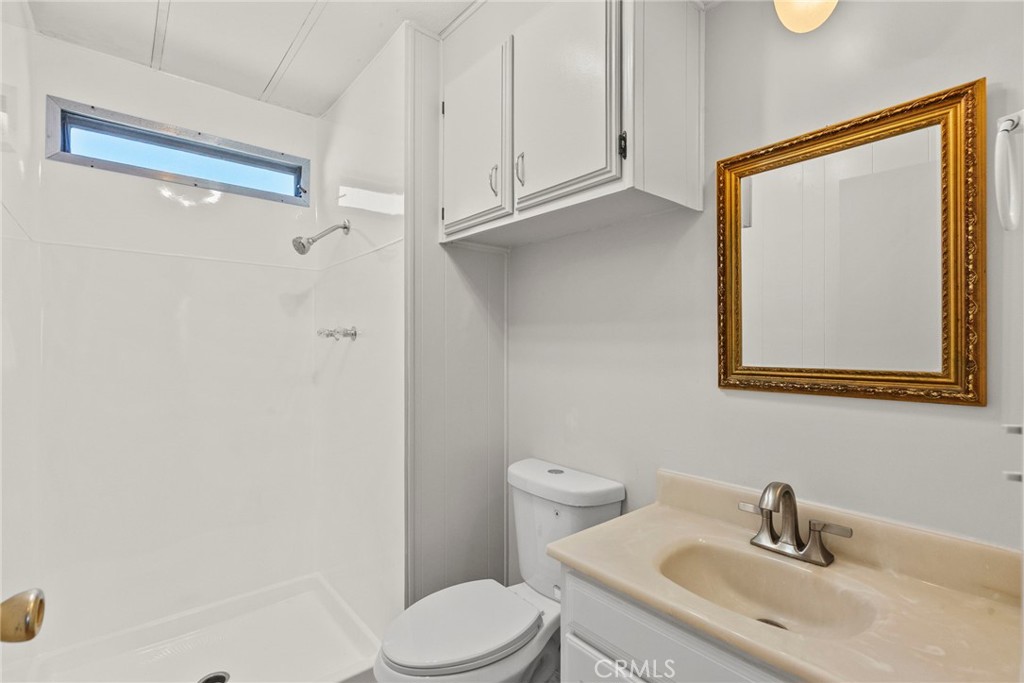 6480 Katherine, Unit 75 Simi Valley, CA 93063 - Photo 8 of 30 a bathroom with a toilet sink and mirror