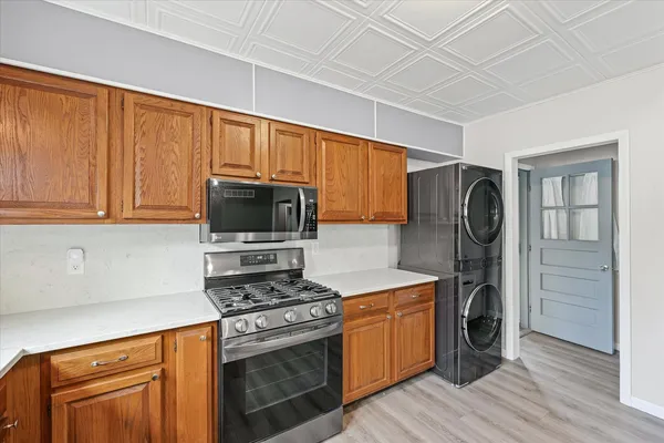 a kitchen with stainless steel appliances granite countertop a stove a refrigerator and a microwave