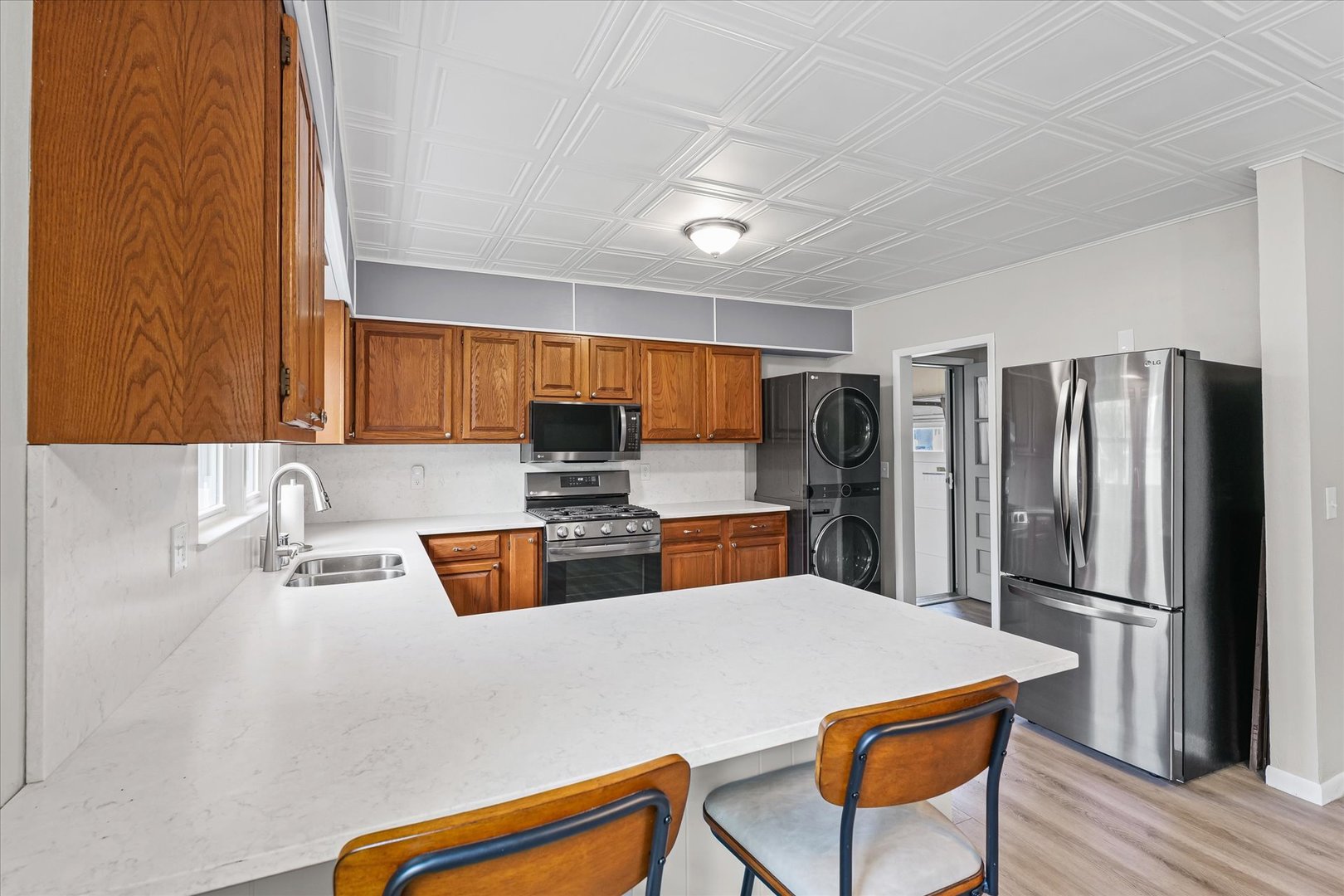 601 West Main Street Clinton, IL 61727 - Photo 18 of 33 a kitchen with stainless steel appliances kitchen island granite countertop a refrigerator and a sink