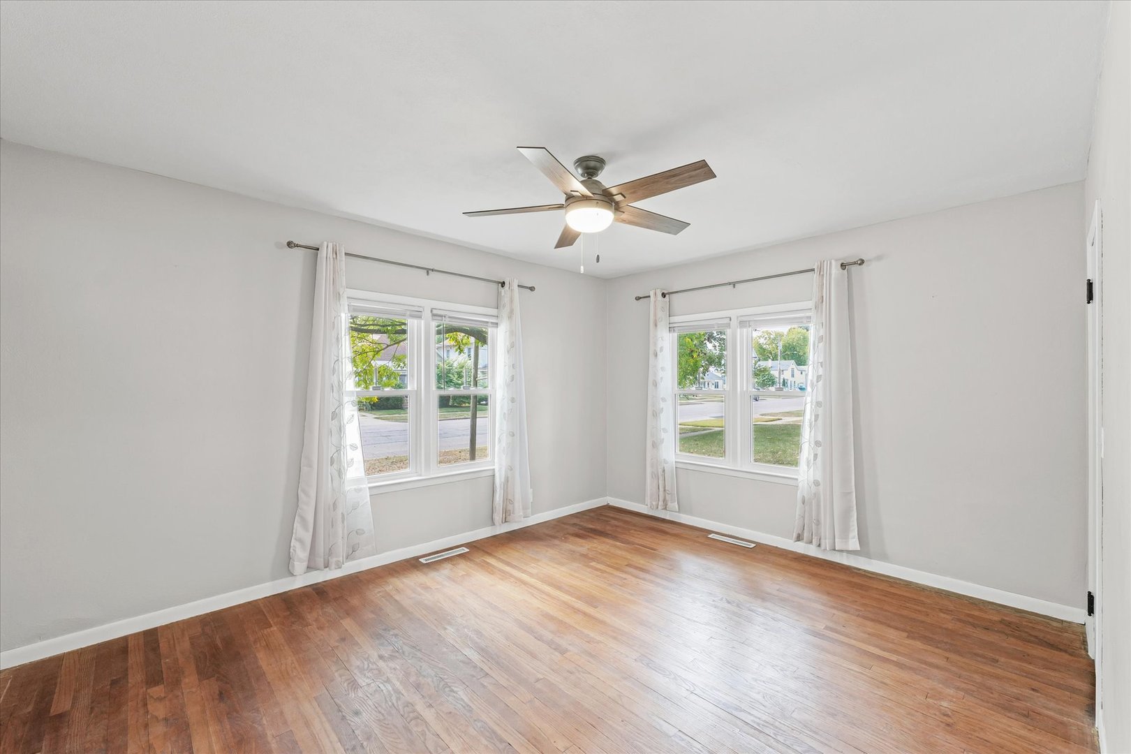 601 West Main Street Clinton, IL 61727 - Photo 23 of 33 a view of empty room with wooden floor and fan