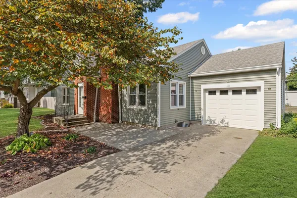 a front view of a house with a garden