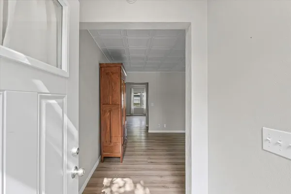 a view of a hallway with wooden floor