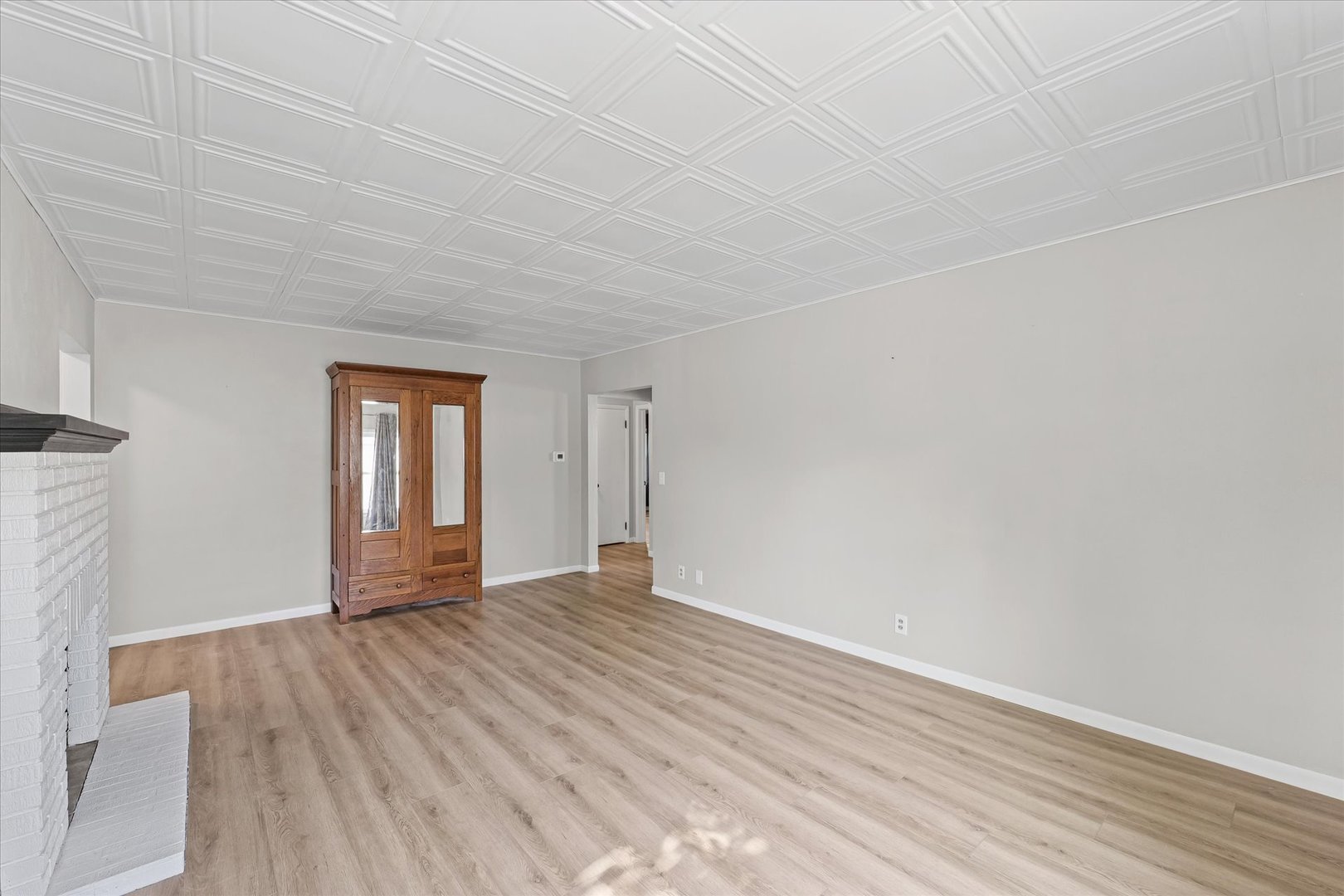 601 West Main Street Clinton, IL 61727 - Photo 7 of 33 a view of an empty room with wooden floor and a window