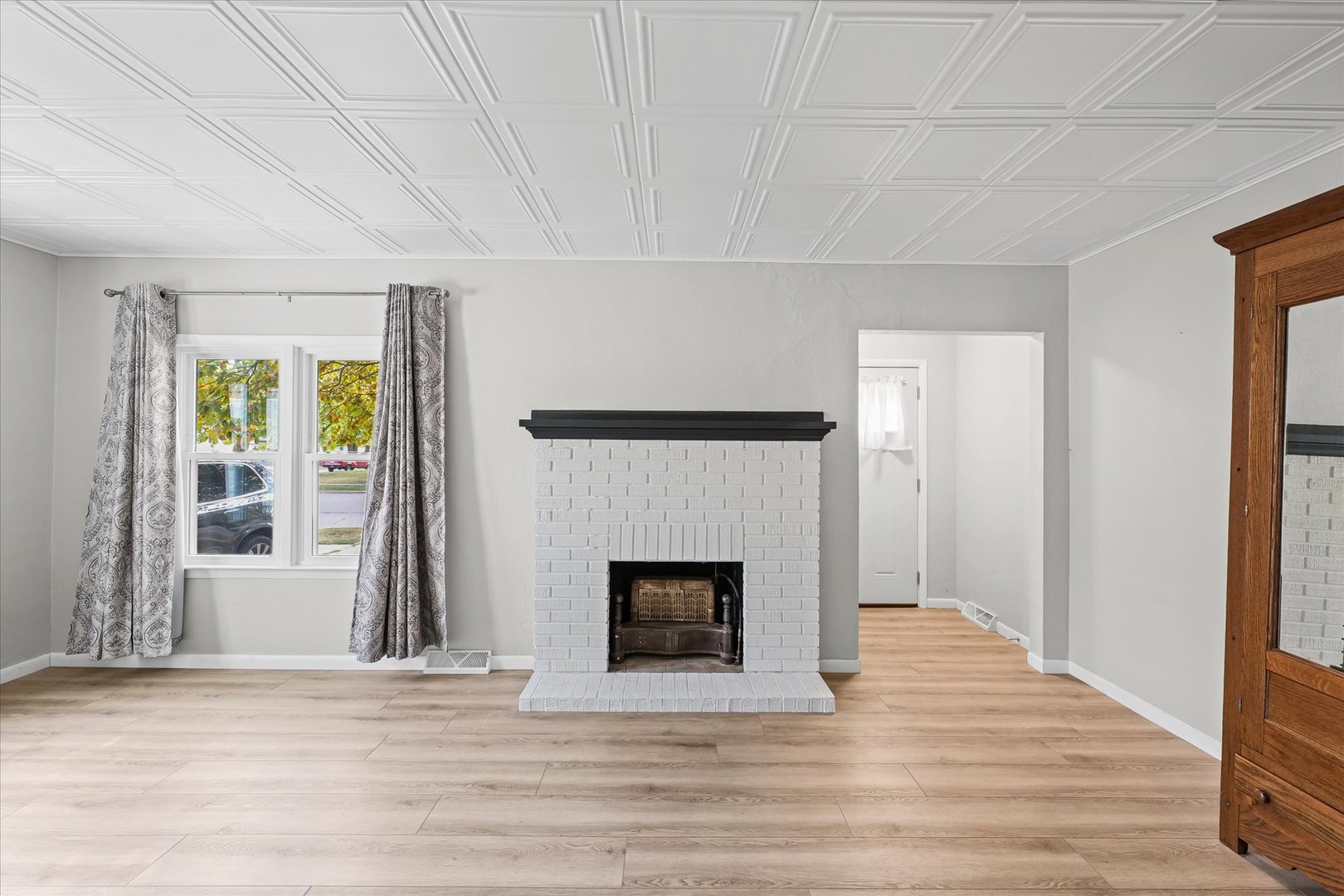 601 West Main Street Clinton, IL 61727 - Photo 9 of 33 a view of an empty room with wooden floor and a window
