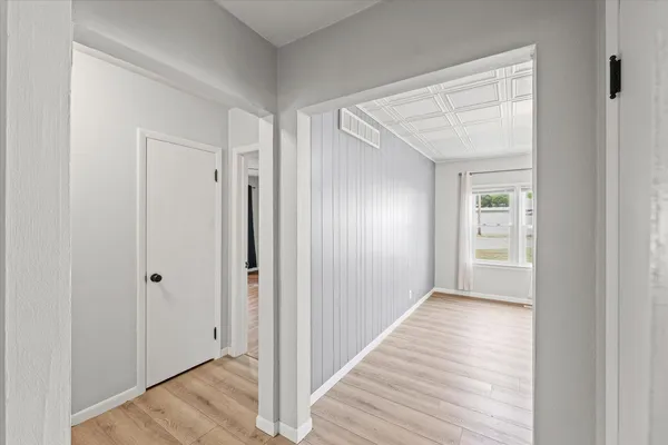 a view of a hallway with wooden floor