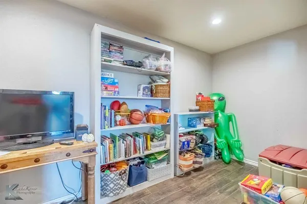 a room with toys and a wooden floor