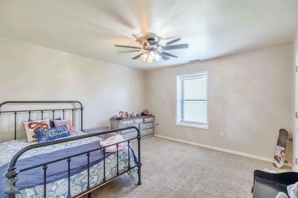 a bedroom with furniture and a window