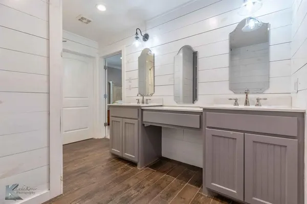 a bathroom with a double vanity sink and a mirror