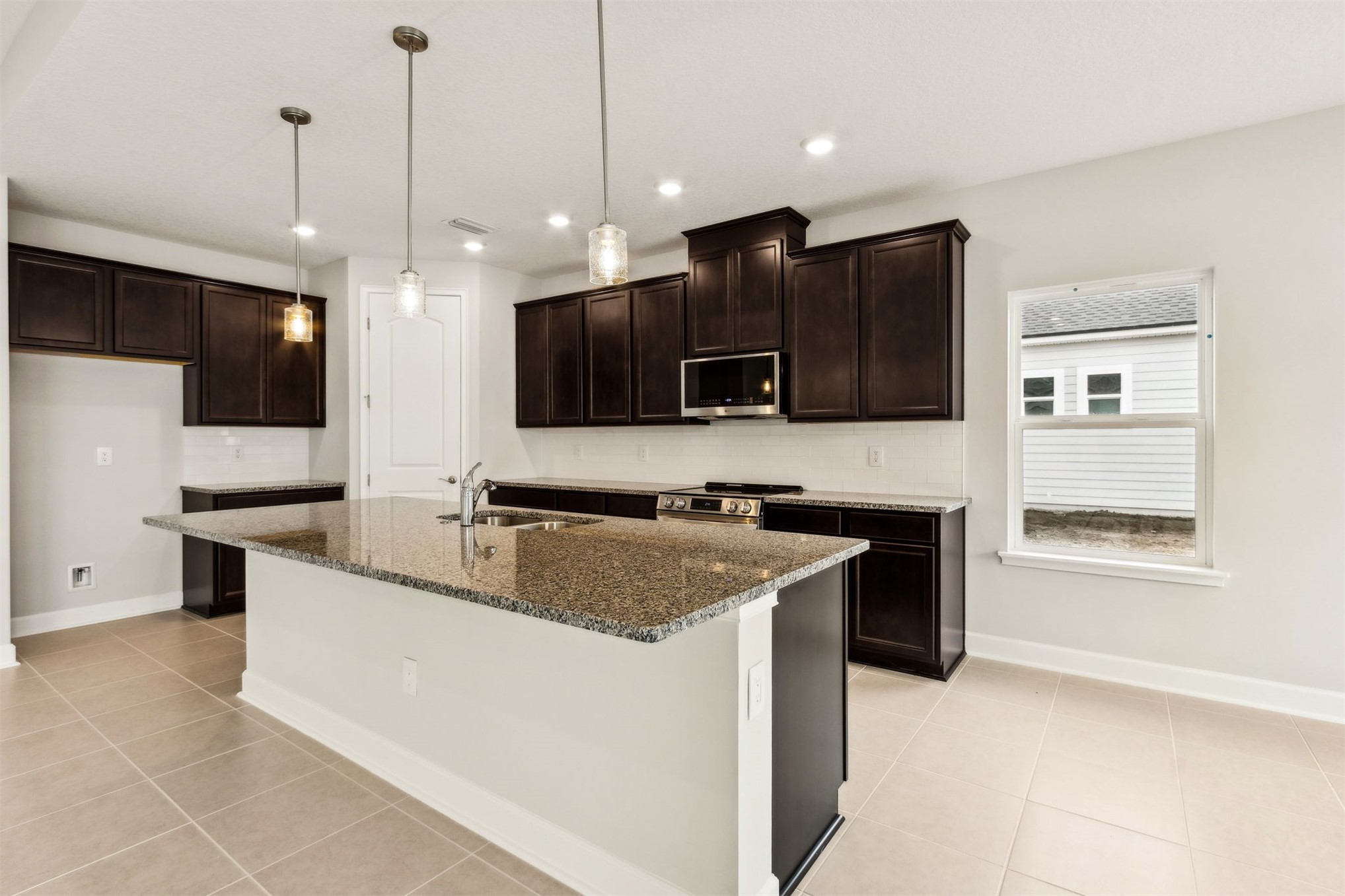 85236 Sandy Rdg Loop Yulee, FL 32097 - Photo 7 of 19 a kitchen with stainless steel appliances granite countertop a sink a stove and a refrigerator