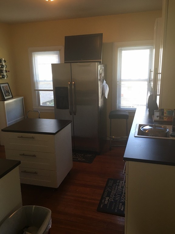 529 White Street Springfield, MA 01108 - Photo 7 of 16 a kitchen with stainless steel appliances granite countertop a refrigerator a stove a sink and a window