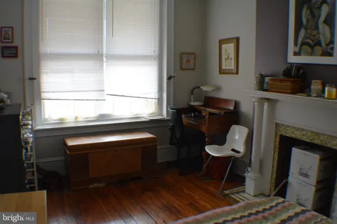 a work place with table chair and a window