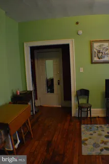 a living room with a table and a chair