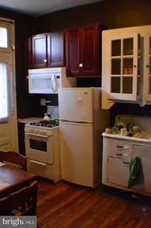 a kitchen with wooden cabinets and a stove top oven