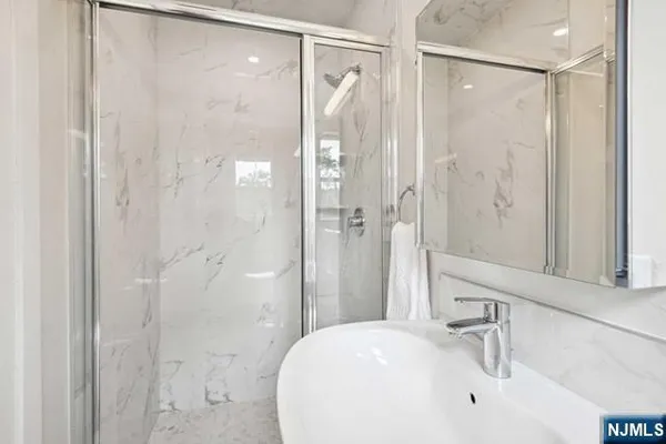 a bathroom with a shower and a sink