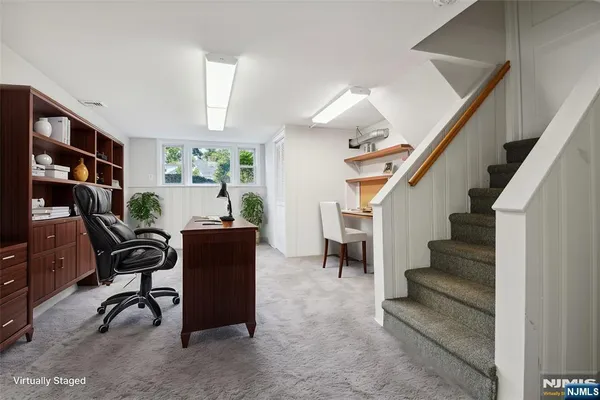 a view of a livingroom with furniture and staircase
