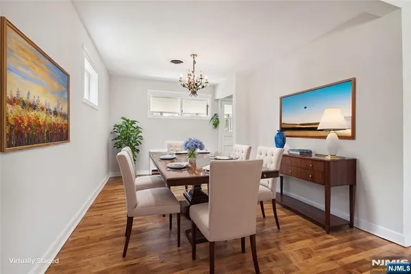 a view of a dining room with furniture and wooden floor