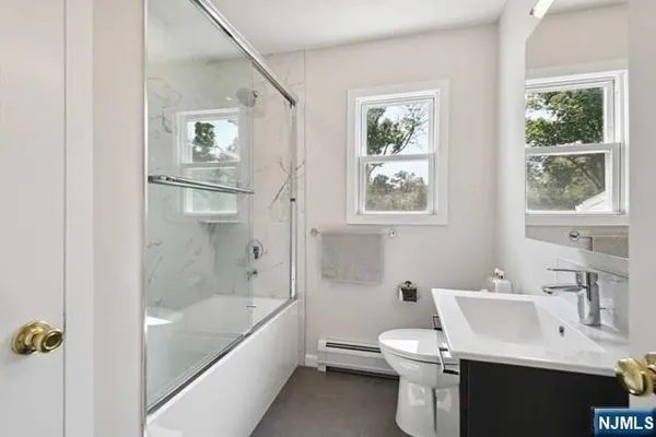 a bathroom with a toilet a sink and bathtub