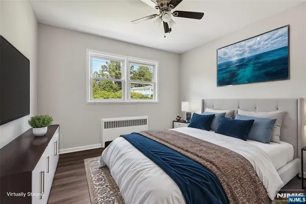 a bedroom with a large bed and a flat screen tv
