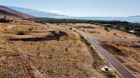 a view of ocean and a mountain
