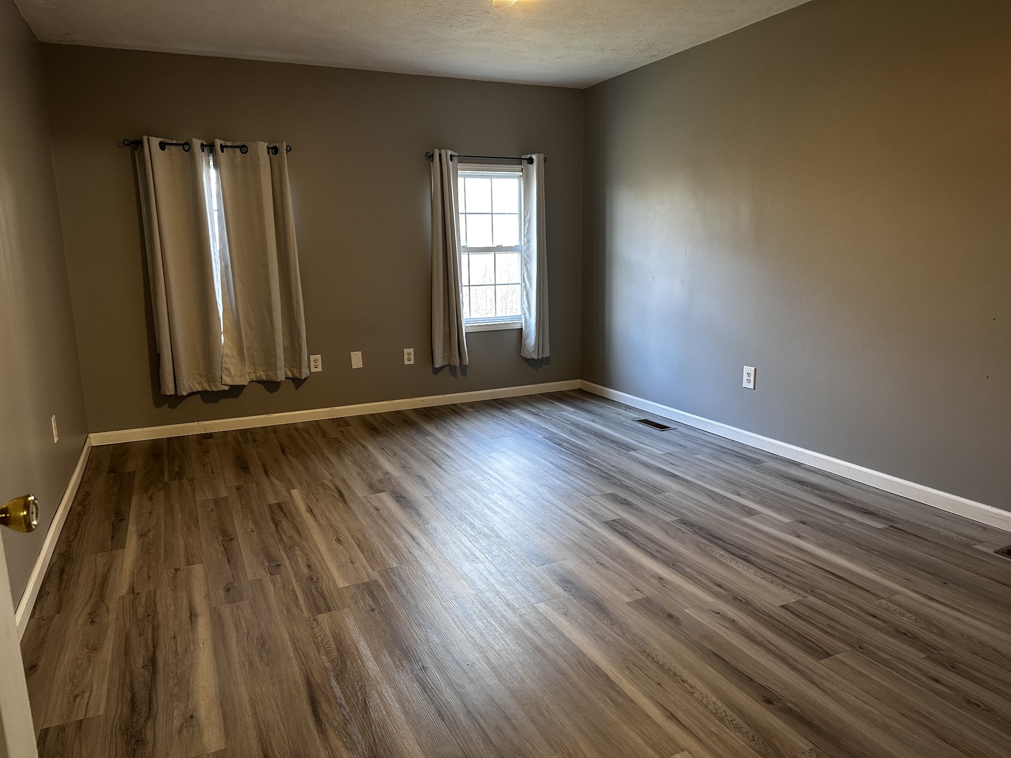 1306 Bumpus Mills Road Dover, TN 37058 - Photo 6 of 9 an empty room with wooden floor and windows