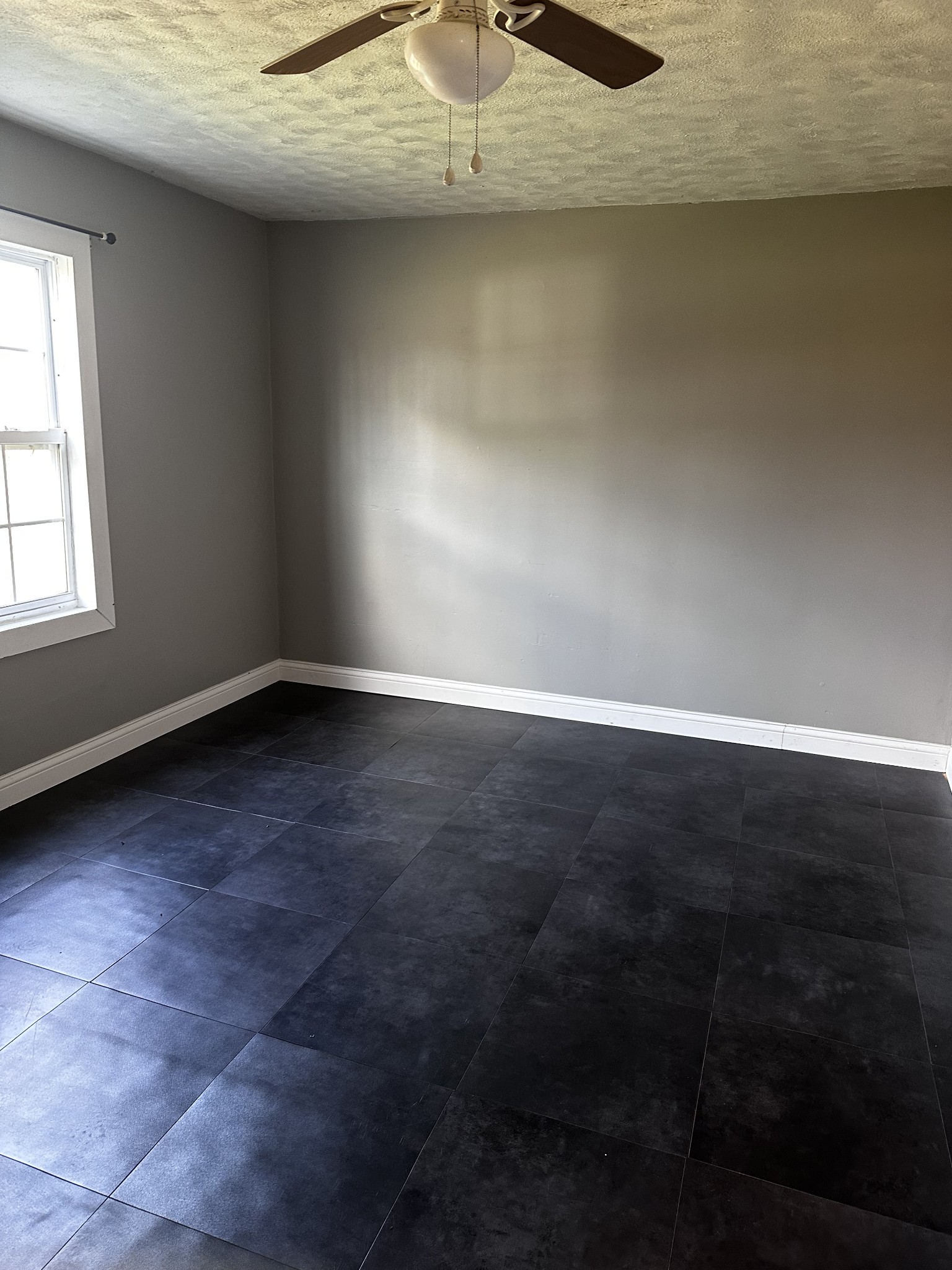 1306 Bumpus Mills Road Dover, TN 37058 - Photo 8 of 9 an empty room with wooden floor and chandelier fan