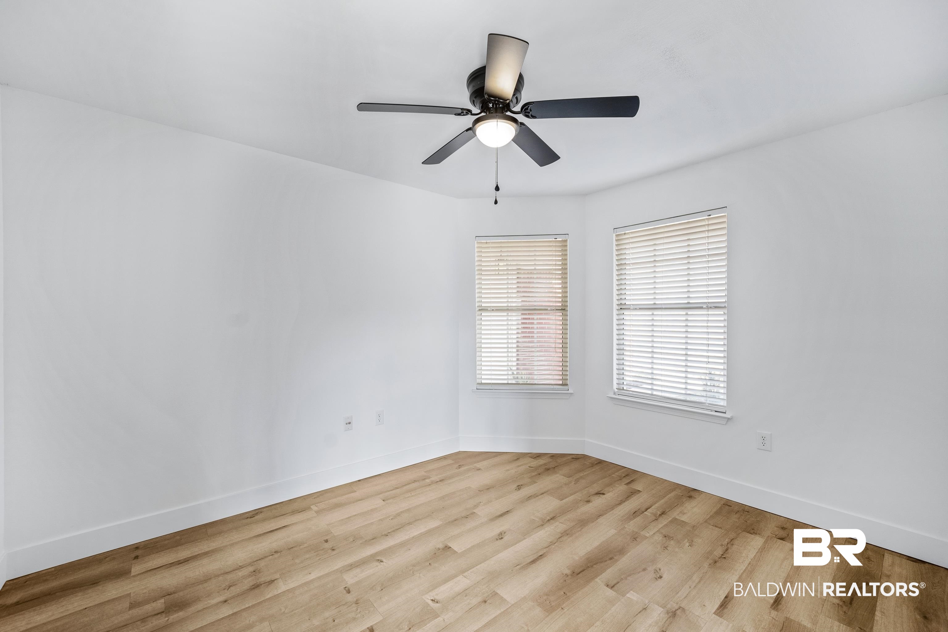 9243 Brookshire Loop Daphne, AL 36526 - Photo 12 of 26 Empty room with ceiling fan and light hardwood / wood-style flooring