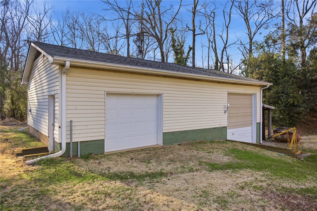 1005 Pinecroft Drive Anderson, SC 29621 - Photo 13 of 50 This functional outbuilding provides ample space for vehicles or a workshop, offering practical versatility.