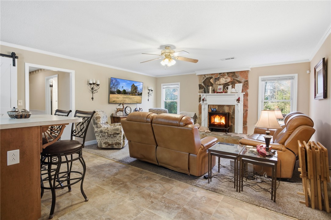 1005 Pinecroft Drive Anderson, SC 29621 - Photo 19 of 50 This inviting living space features a cozy fireplace, creating an ideal setting for relaxation.